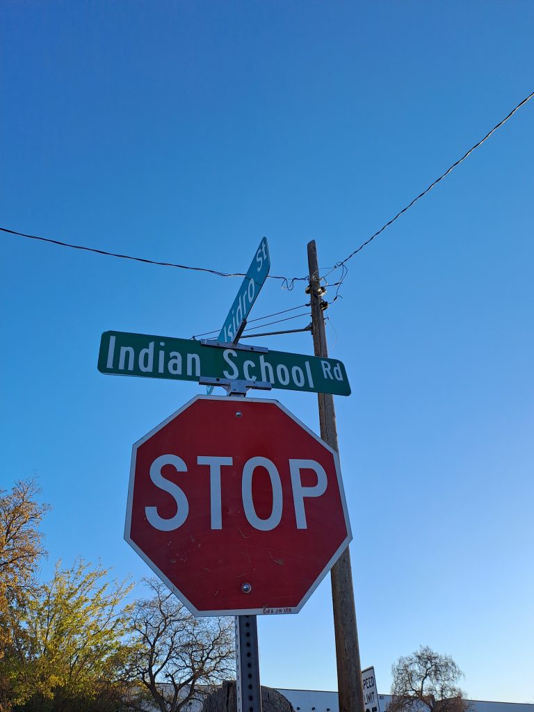 The author added a photo of the Indian School Road sign on top of a stop sign, in Albuquerque.