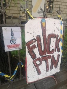 Protest signs in front at the Russian embassy in Riga. The signs say: “The truth will prevail, and Putin will fail” and “Fuck PTN”.