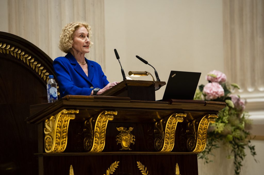 Professor Martha Nussbaum giving a speech from the podium.