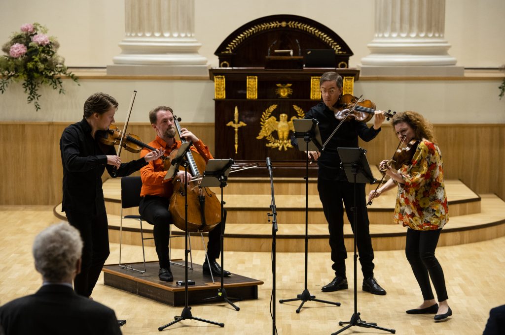 A string quartet play in the festive hall. 