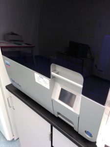 Closeup of a QIAcube DNA extraction machine.