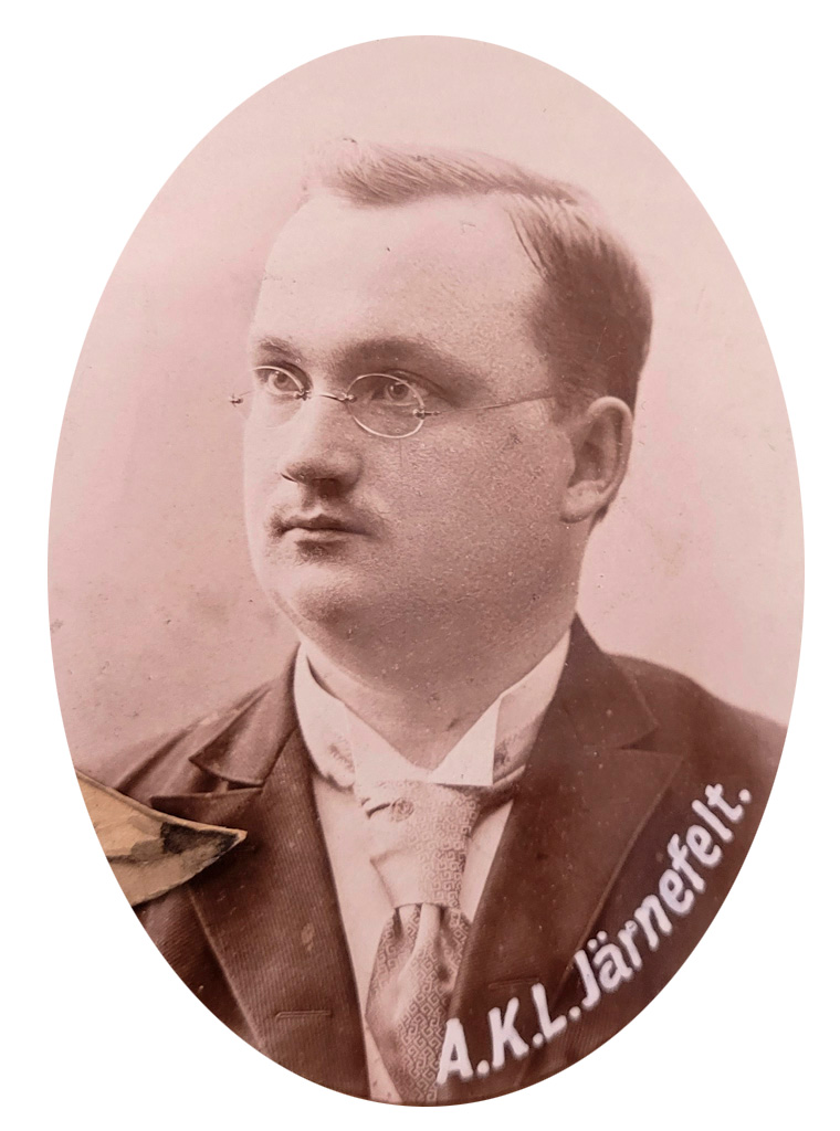An oval photo of a fairly young man wearing glasses.