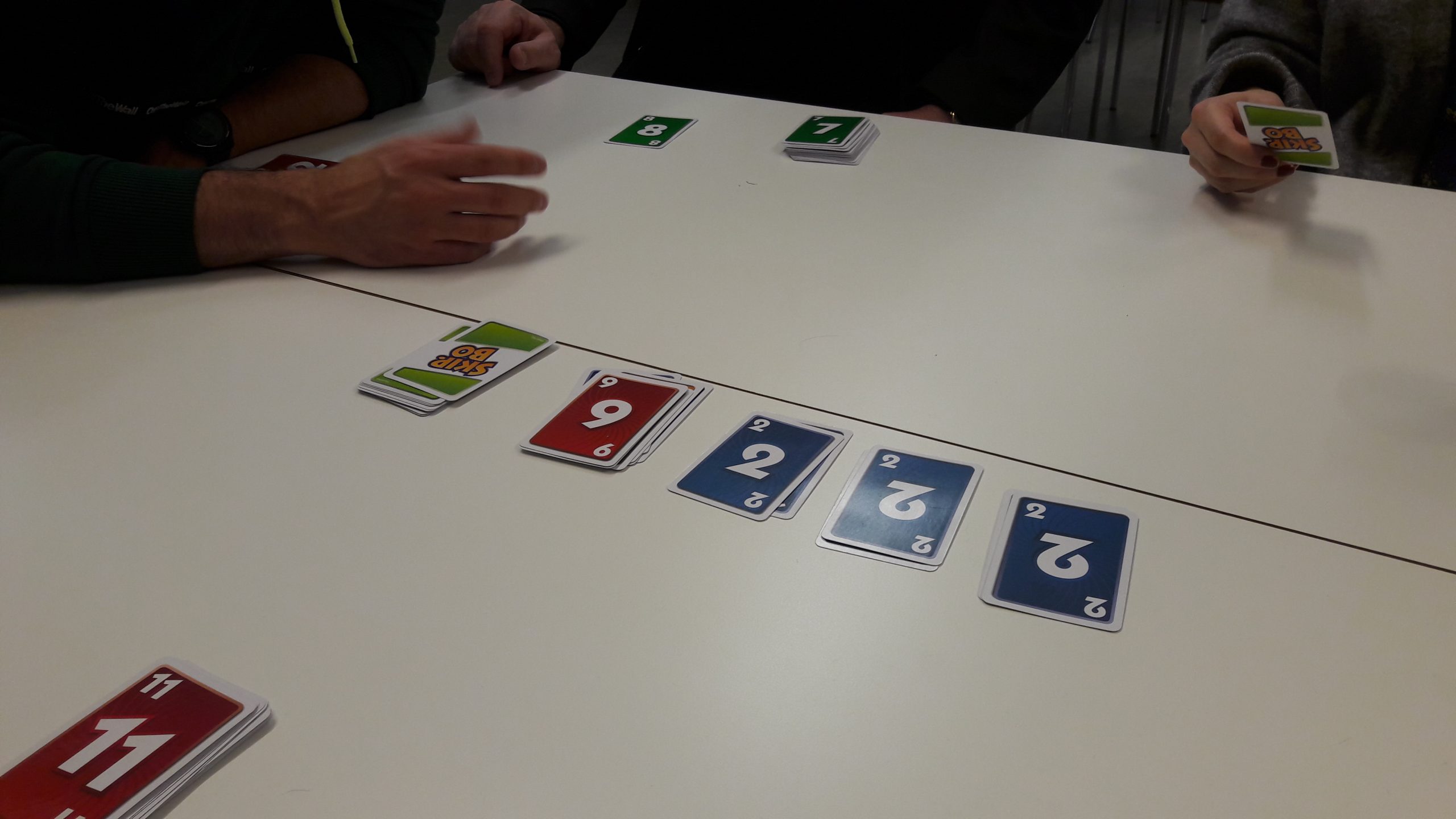 People playing the card game Skip-Bo.