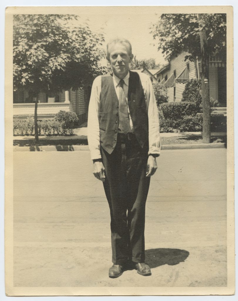 Matti Huhta portrait. Older man standing on a street.